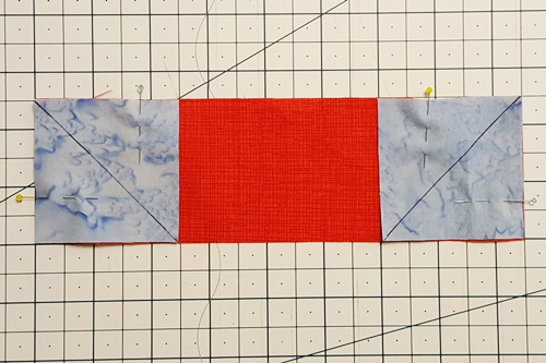 Step 2 stitch and flip: Right sides together, place one square in each corner of the rectangle and pin. Step 2 stitch and flip: With the right sides together, place one square in each corner of the rectangle and pin.