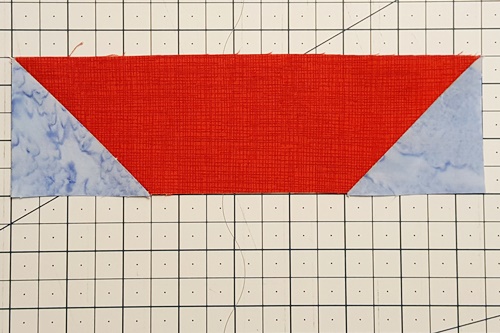 Step 6 stitch and flip: Flip both corners right side up to reveal the new corners (triangles). Step 6 stitch and flip: Flip both corners right side up to reveal the new corners (triangles).