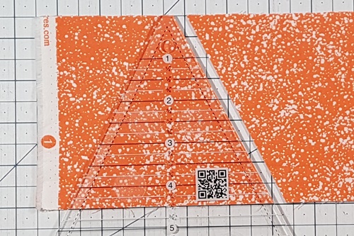 Step 1 Triangle in a Square: Cut strip 1/2 inch larger than finished size of required unit. Place blunt tip of Tri tool at top of strip and measurement line along bottom edge. Make a cut. Step 1 Triangle in a Square: Cut strip 1/2 inch larger than finished size of required unit. Place blunt tip of Tri tool at top of strip and measurement line along bottom edge. Make a cut.