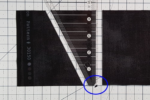 Step 7 Triangle in a Square: Use a rotary cutter to cut away the tiny piece of fabric along slanted edge of the ruler's tip. Step 7 Triangle in a Square: Use a rotary cutter to cut away the tiny piece of fabric along slanted edge of the ruler's tip.