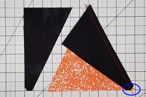 Step 12 Triangle in a Square: Right sides together, align side triangle edge of tip that was cut away along the bottom edge of center triangle. Stitch the right side triangle to the center triangle. Step 12 Triangle in a Square: Right sides together, align side triangle edge of tip that was cut away along the bottom edge of center triangle. Stitch the right side triangle to the center triangle.