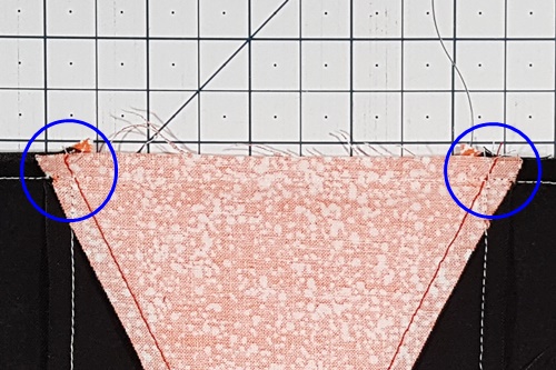 Triangle in a Square Star close-up of where the seams of the center triangle
and the side triangles intersect. Triangle in a Square Star close-up of where the seams of the center triangle
and the side triangles intersect.